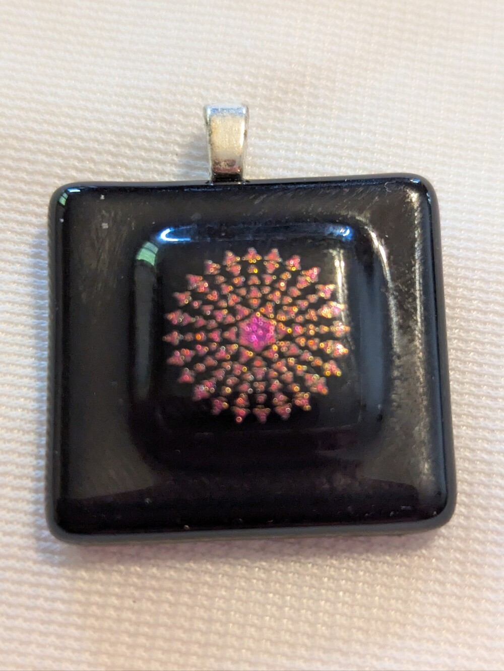 Black Pendant Featuring A Geometric Firework Pattern With Pink Center Handmade